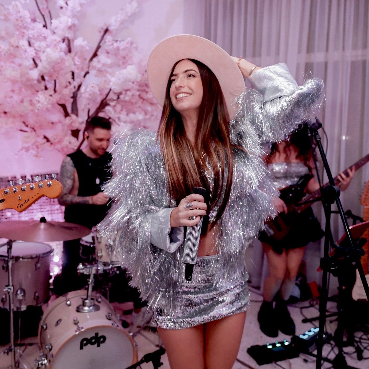 Georgia performing with cherry blossom backdrop at a Dubai event